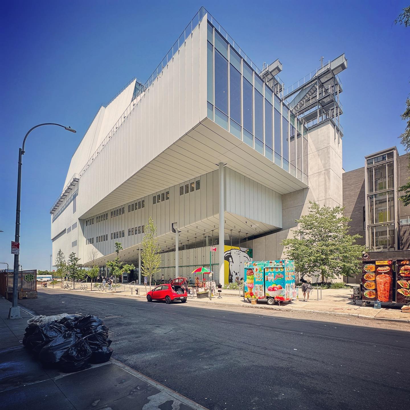The museum’s pale volumes and elevated glazing above an active street frontage.