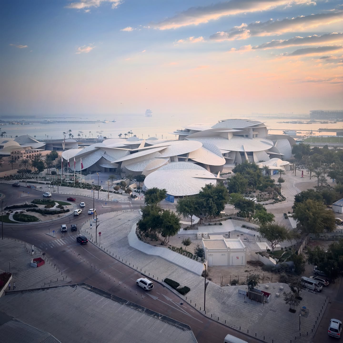 The museum’s interlocking pale discs seen above gardens, roads and the waterfront.