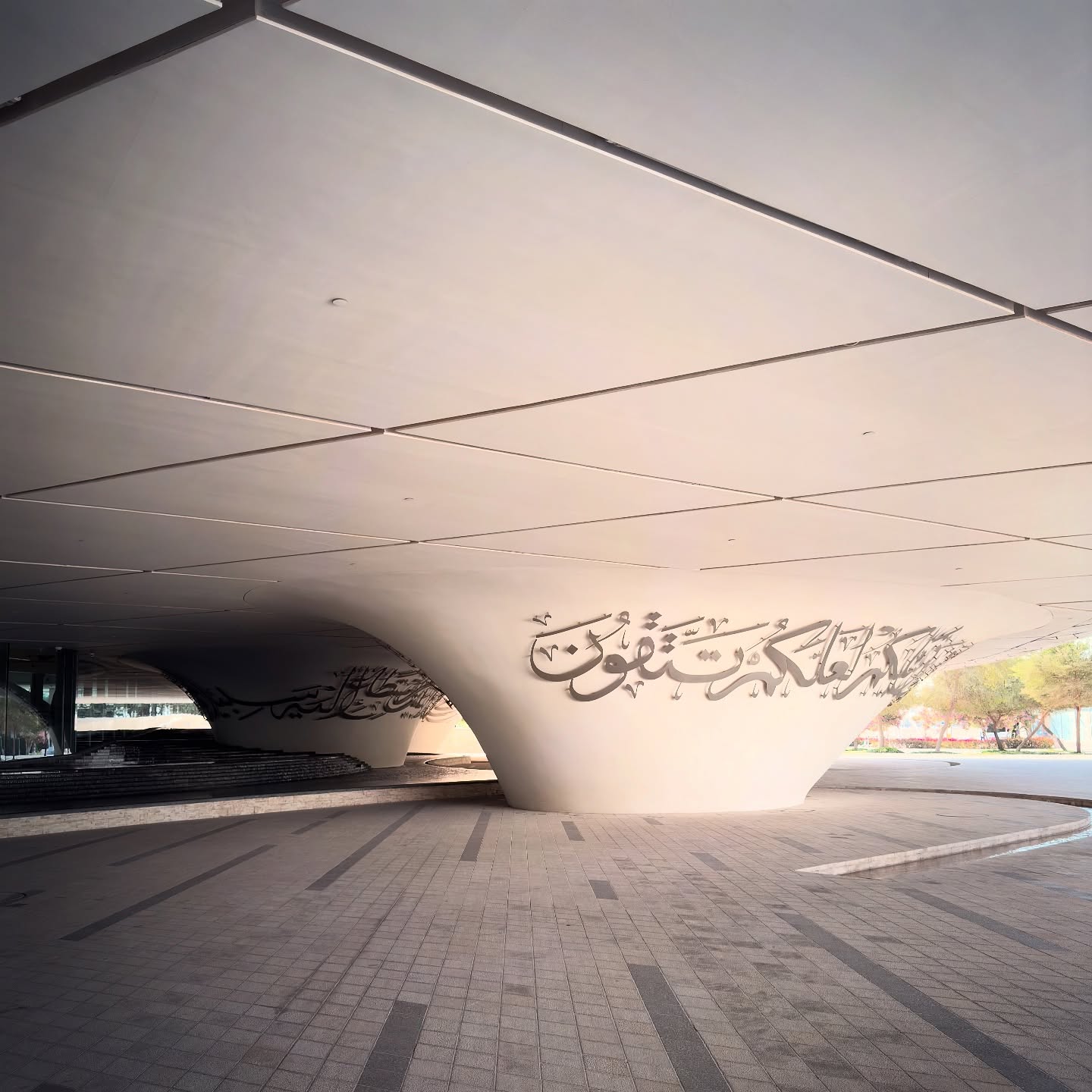 Calligraphic detailing and sculpted supports beneath the mosque’s sweeping roof.