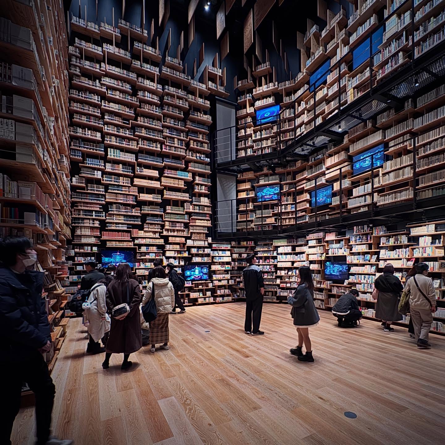 Tall walls of books surrounding visitors at Tokorozawa Sakura Town.