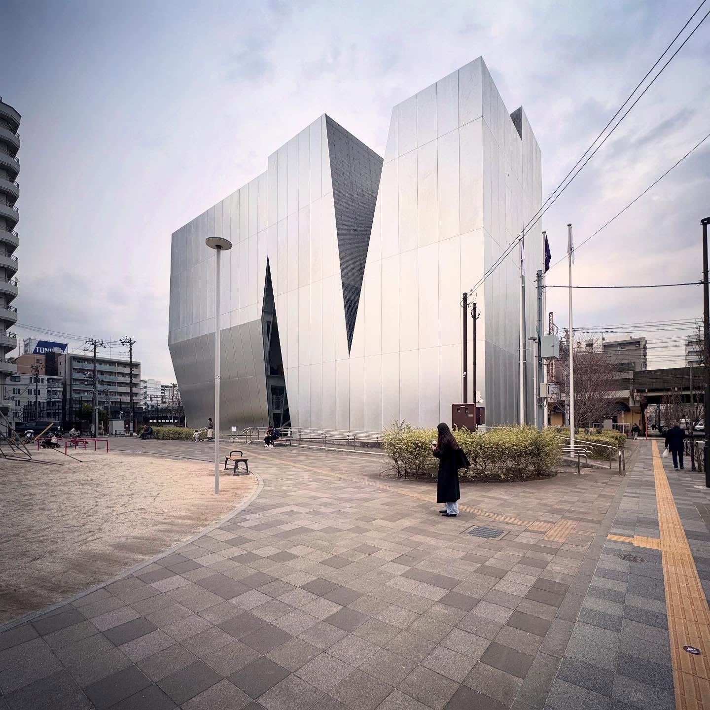 Angular metal-clad volumes and a plaza outside Sumida Hokusai Museum.