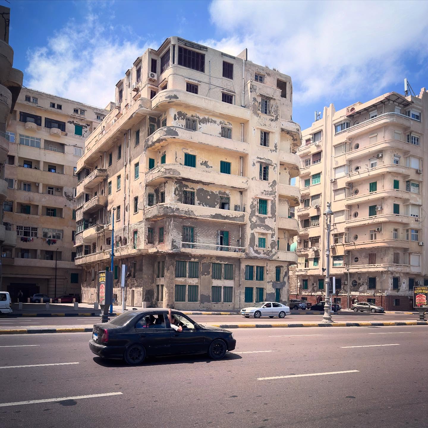 Balconies, shutters and pale historic façades lining an Alexandria street.