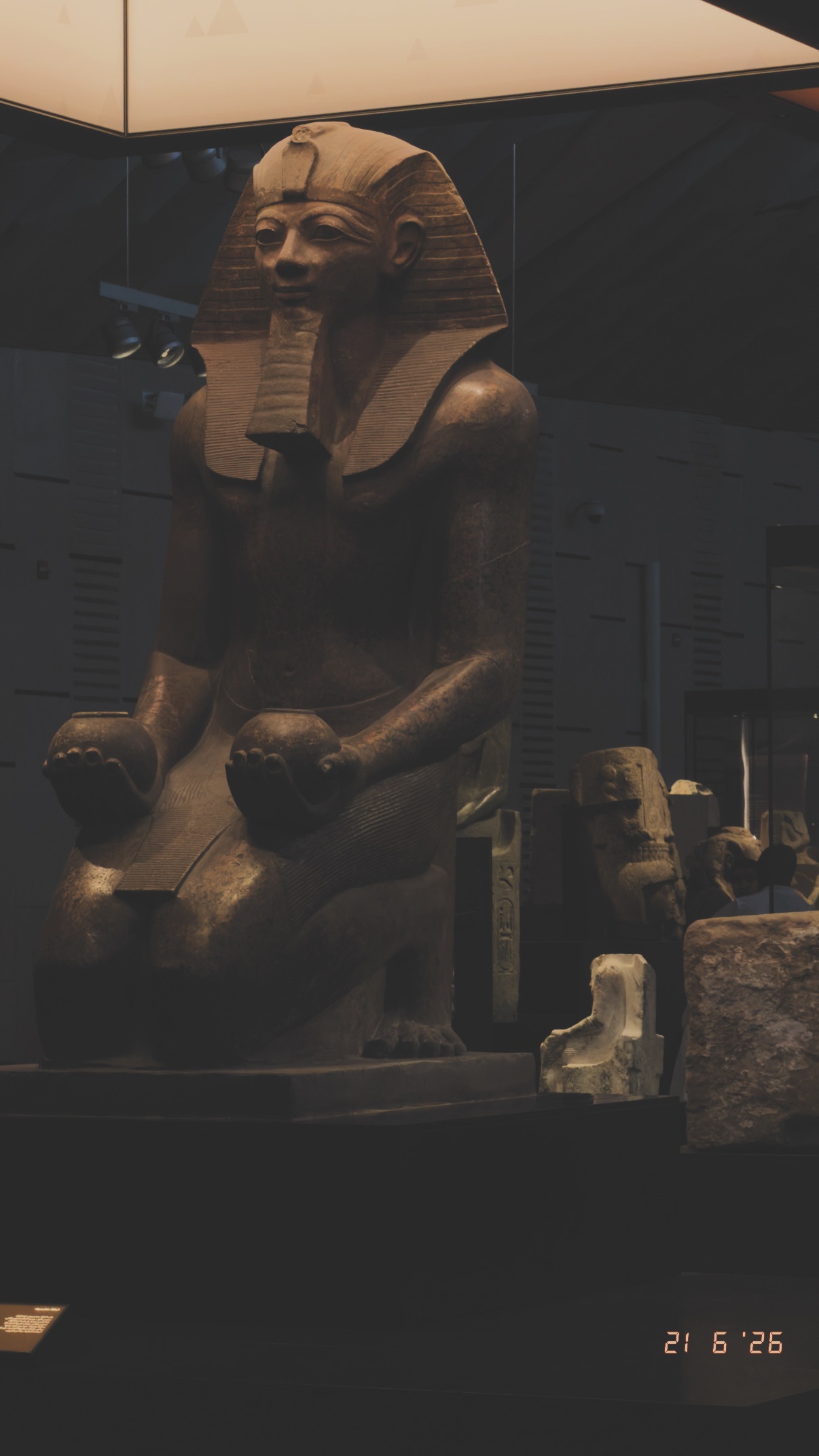 Seated figure in the gallery. Grand Egyptian Museum.
