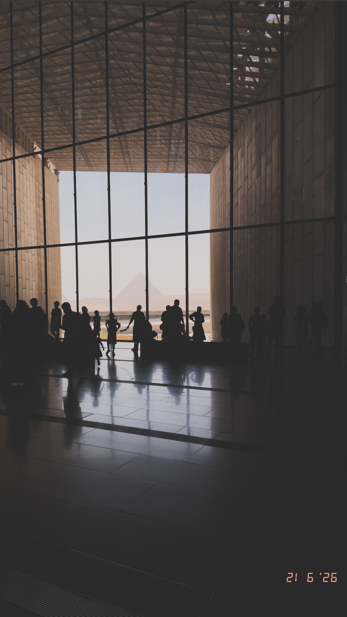 Visitors silhouetted against the landscape. Grand Egyptian Museum.
