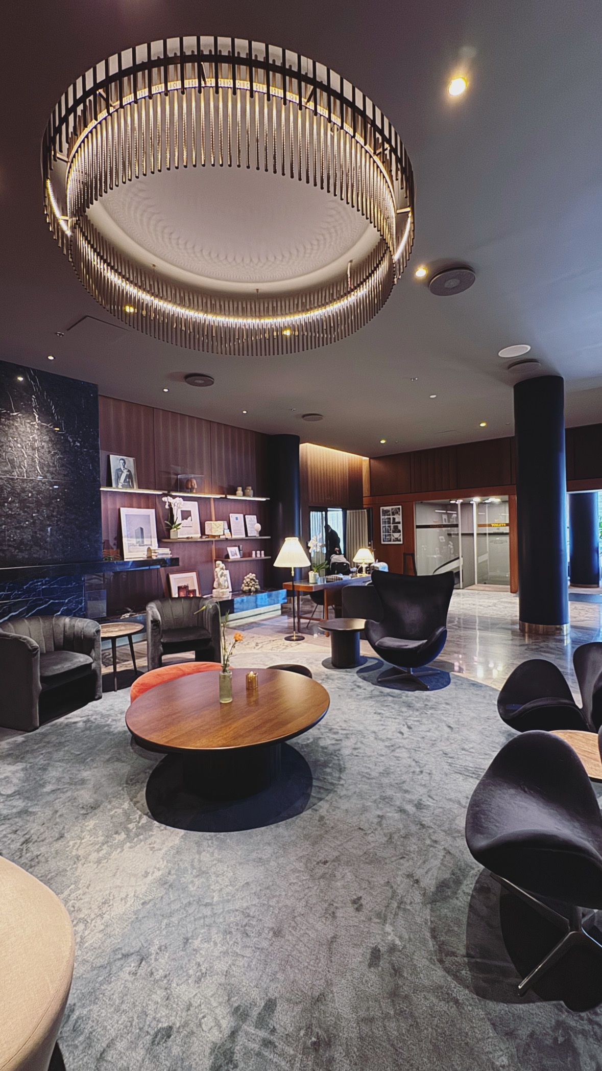 A circular light above the room. City and interiors.