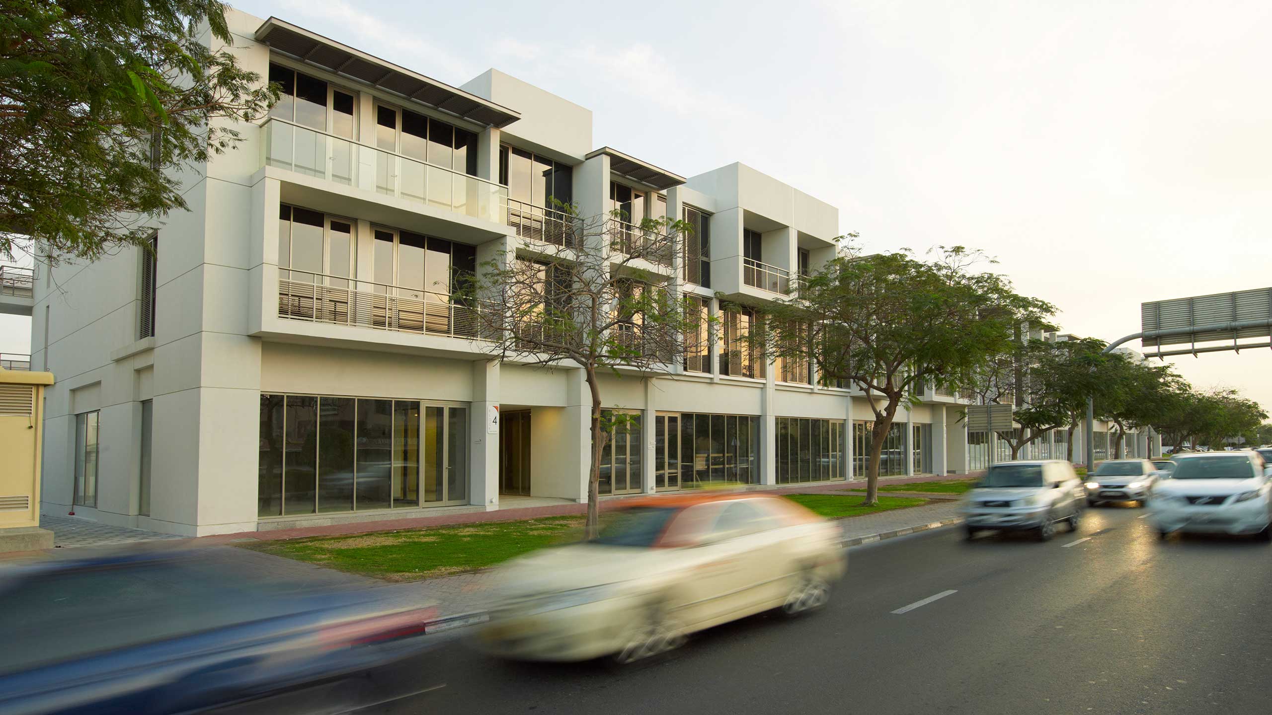 Wasl Square’s white façades, shade screens and active street edge.