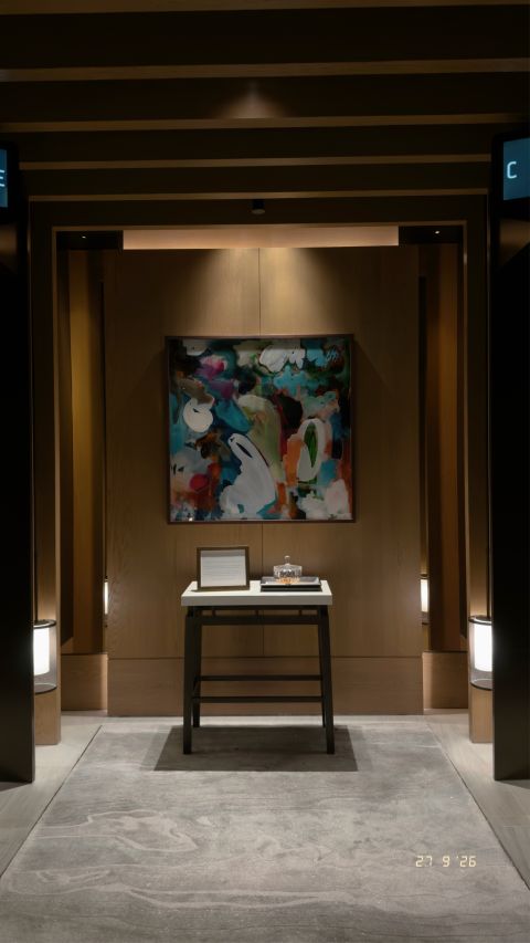Artwork at the end of a timber-lined passage